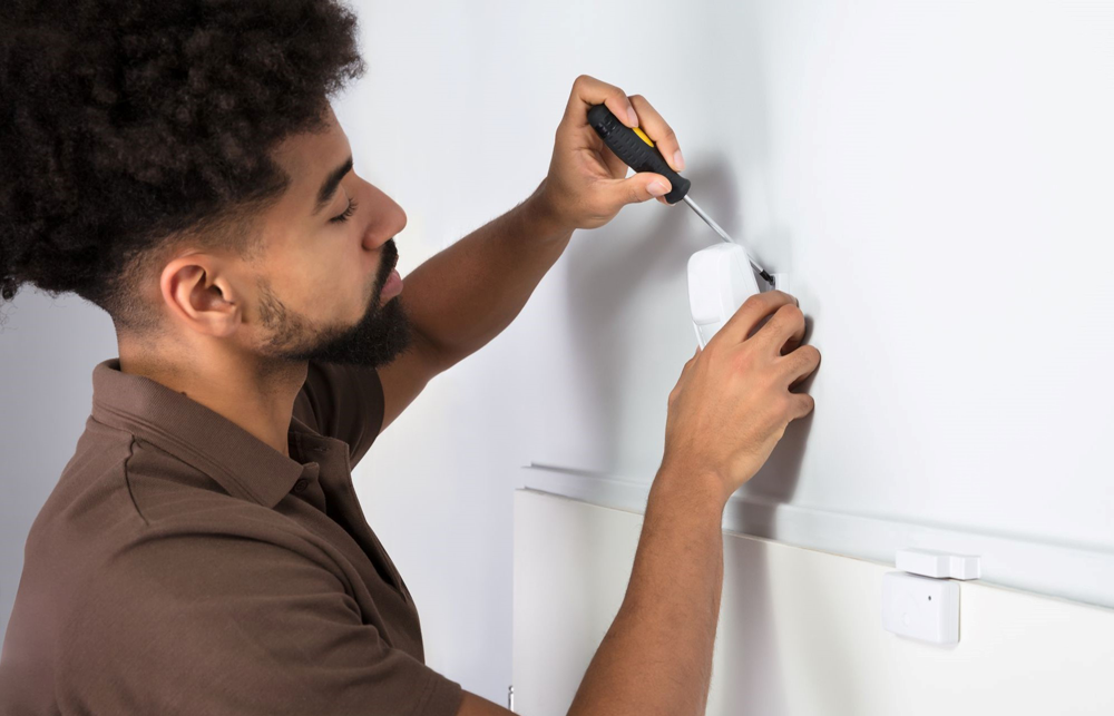 Technician installing motion sensor