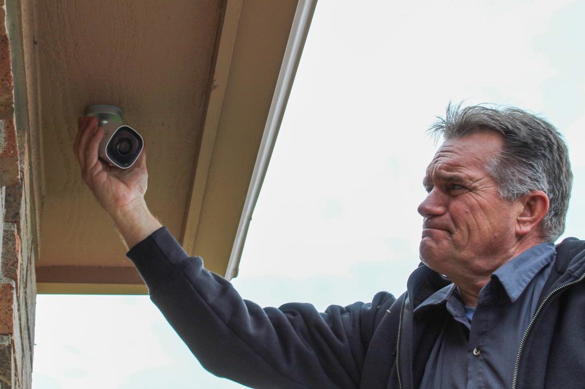 Technician finishing installing a new outdoor security camera