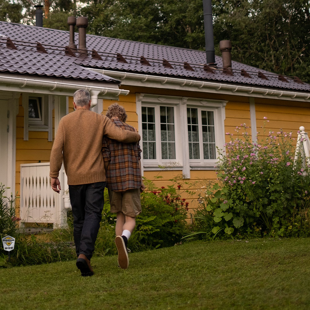 Grandfather with grandson walking into a house protected by Frase Protection
