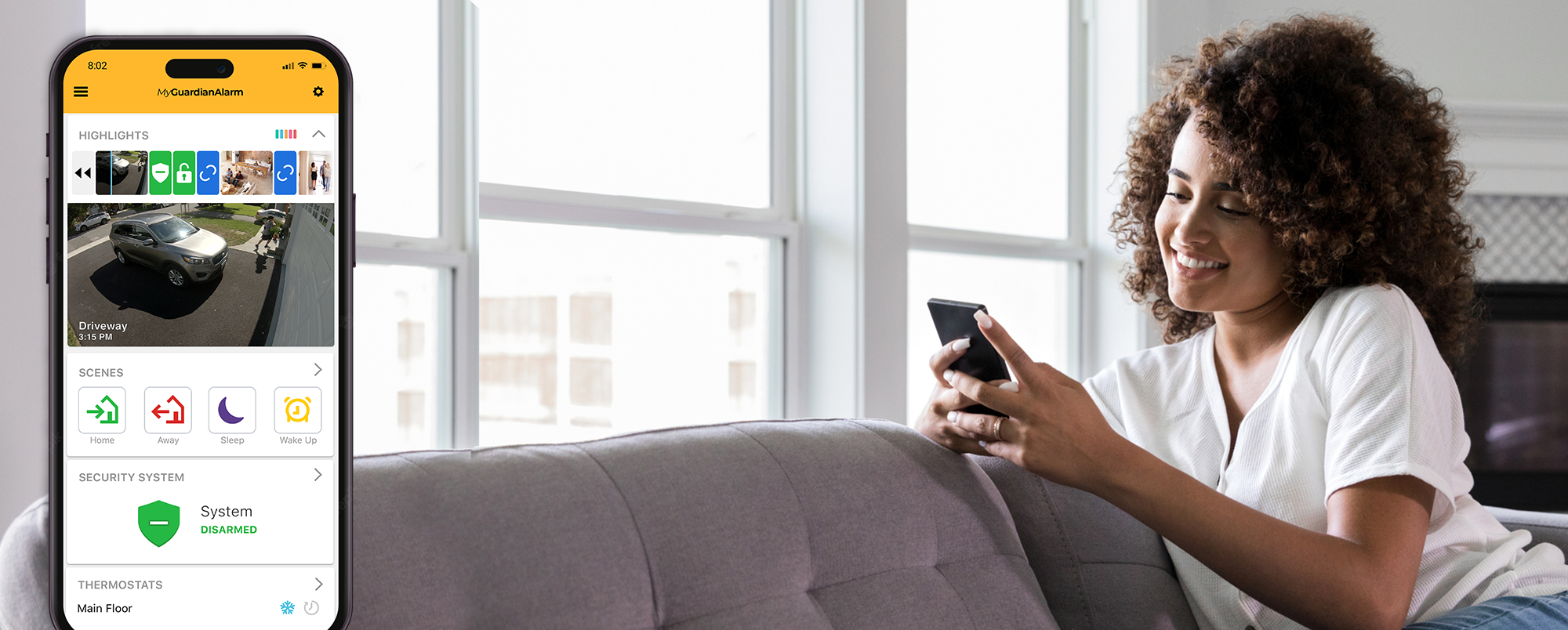 African American woman on phone looking at security system app with video recording